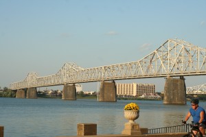 Cyclist and Bridge crossing Ohio River in Louisville